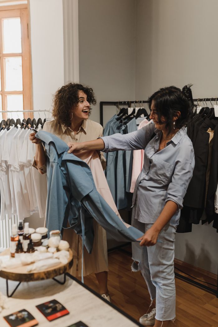 The Art of Drawing Readers In: Your attractive post title goes here Two women enjoying their shopping experience in a stylish boutique.