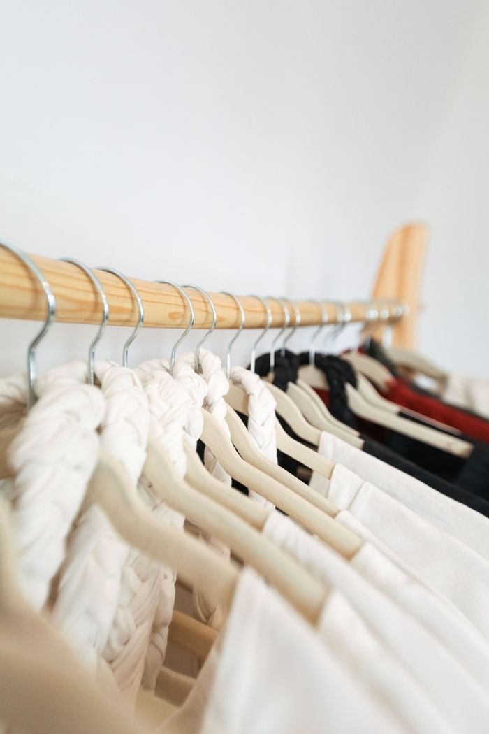 Crafting Captivating Headlines: Your awesome post title goes here A row of elegant garments on hangers in a minimalist wardrobe setting.